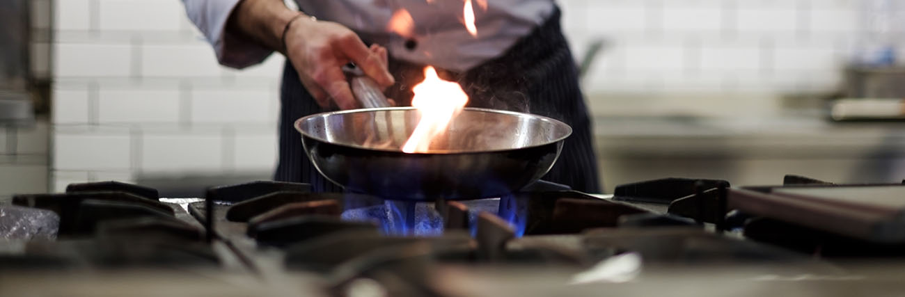 chef cooking on gas hob